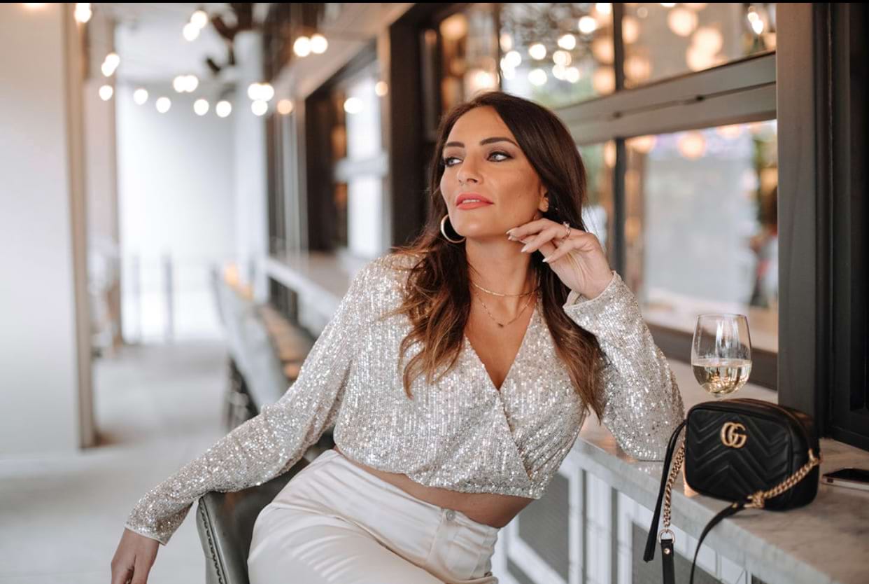 Dr. Tania King-Mohammad looking fabulous with a glass of wine at alfresco eatery